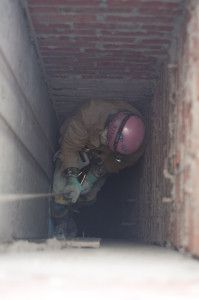 a worker descends into large mines on special equipment